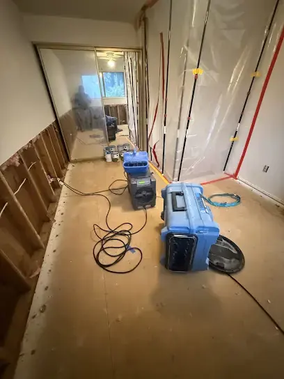 Plastic containment, a dehumidifier and an air scrubber drying a stripped hallway in Gresham, OR