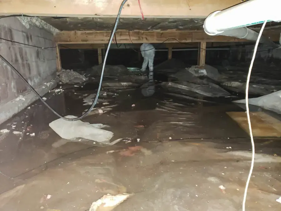Standing water across the vapor barrier of a flooded crawl space, crawl space water damage in Gresham, OR