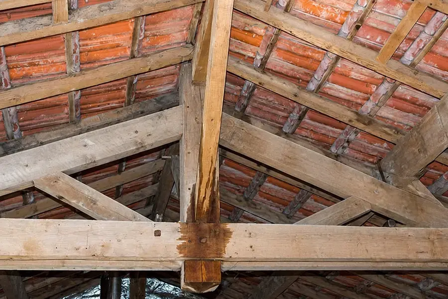 Water staining running down attic rafters and a beam after a roof leak, Gresham, OR
