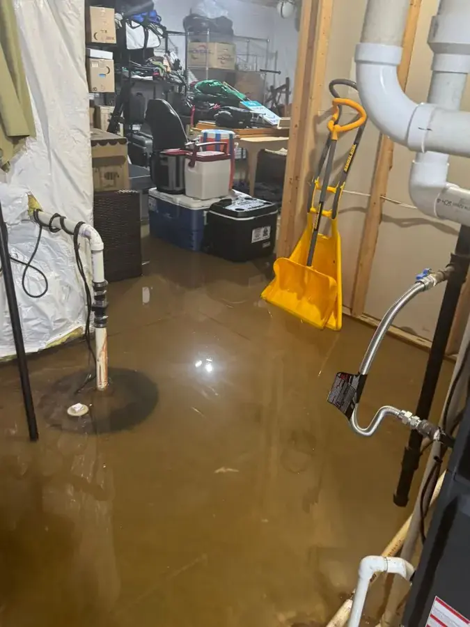 Water covering a basement floor around the sump pit after a pump failure, Gresham, OR